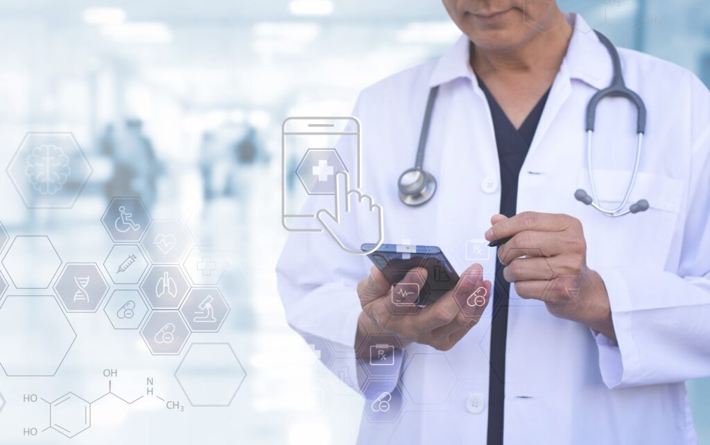 A physician in a hospital uses their smartphone to check patient data, represented by various health symbols hovering in the air.
