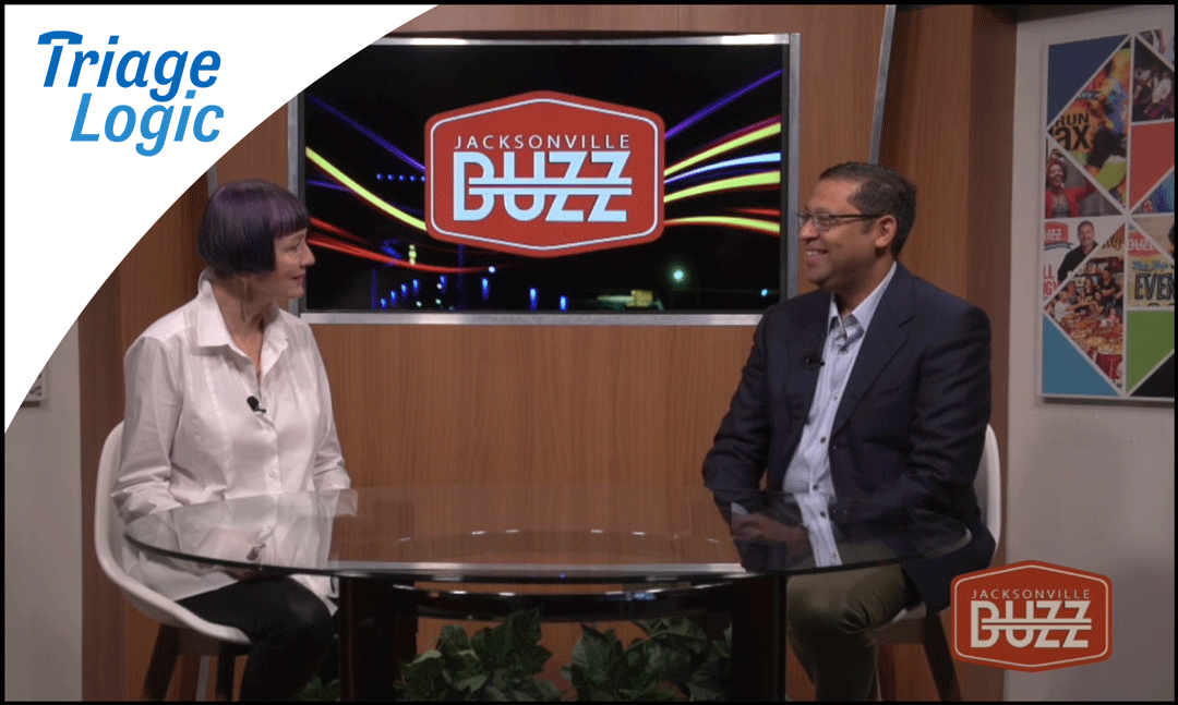 Dr. Ravi Raheja sits with Adrienne Houghton at a table interview with Buzz TV.