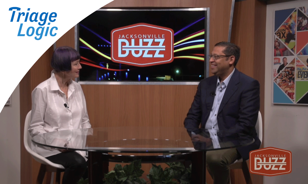 Dr. Ravi Raheja sits with Adrienne Houghton at a table interview with Buzz TV.
