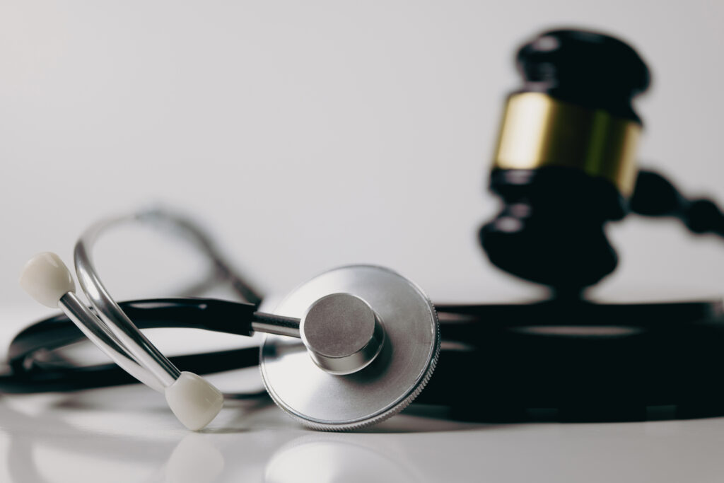 TriageLogic Concept for inaccurate medical messages: a stethoscope and judge's gavel represent liability for medical answering services.