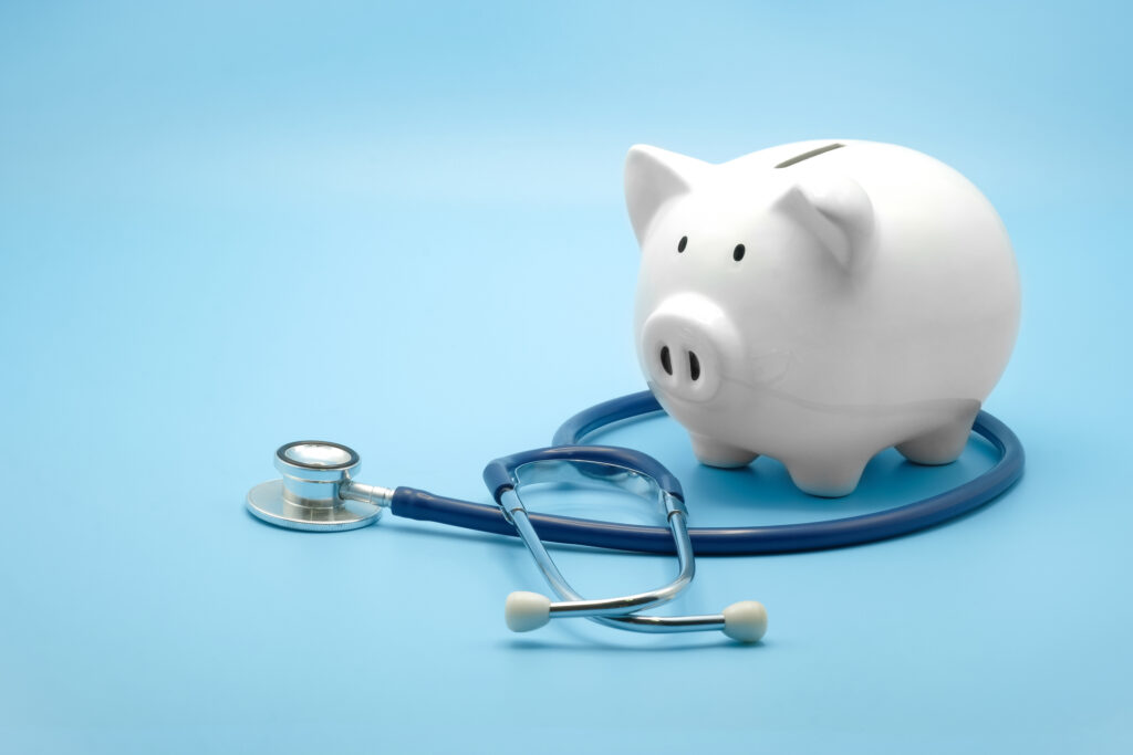 A stethoscope wraps around a piggy bank to represent lower healthcare costs.