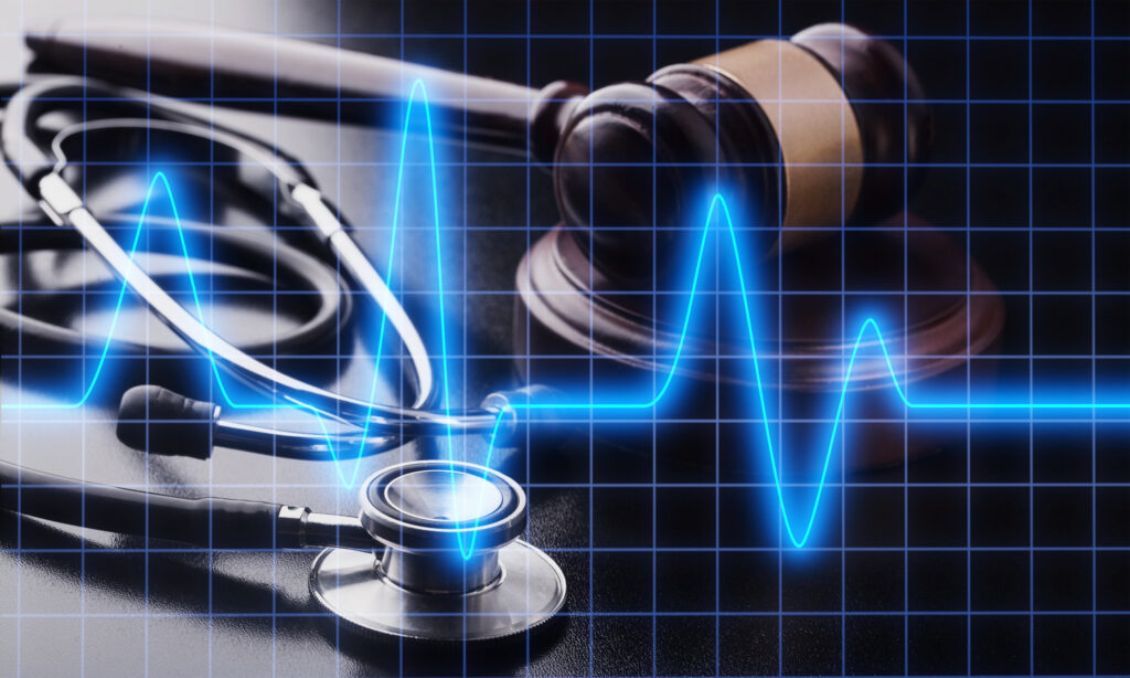 Medical liability concept for initial patient messages: a heart monitor graph is superimposed over a stethoscope and gavel.