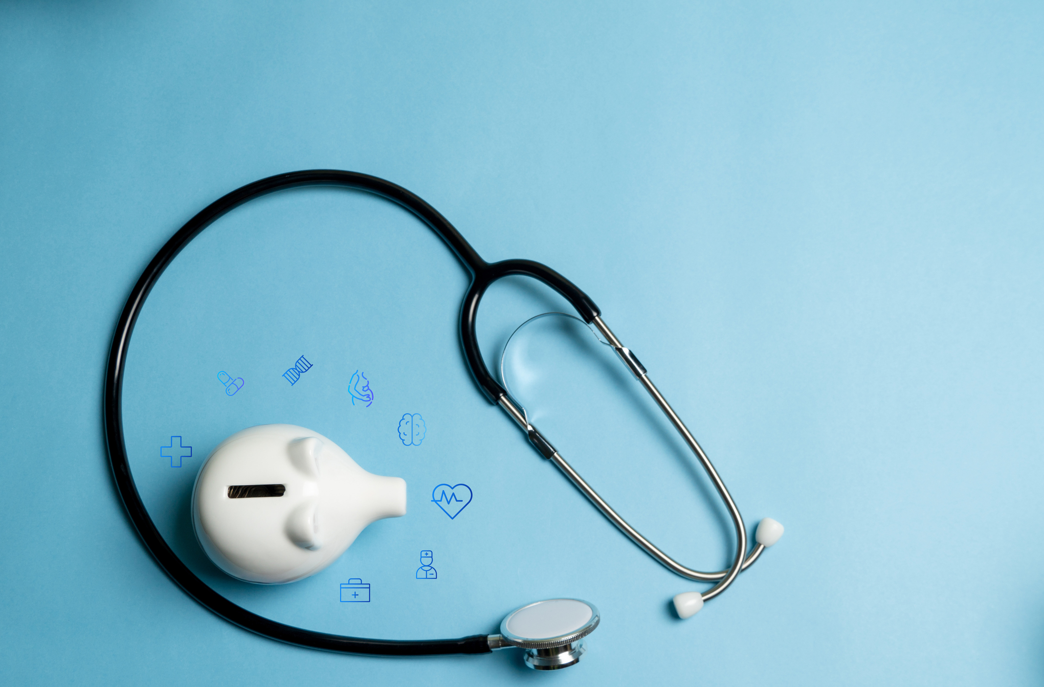 A white piggy bank surrounded by medical icons and a stethoscope represent the financial implications of a healthcare data breach.