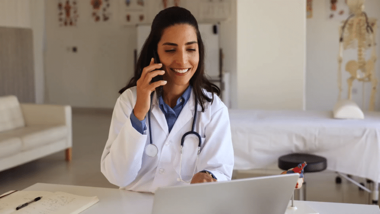 A nurse asks a patient triage questions over the phone while viewing their file on her laptop. schmitt-thompson protocols. nurse triage on call. remote patient monitoring. telehealth solutions. telehealth technology. telehealth using ai.