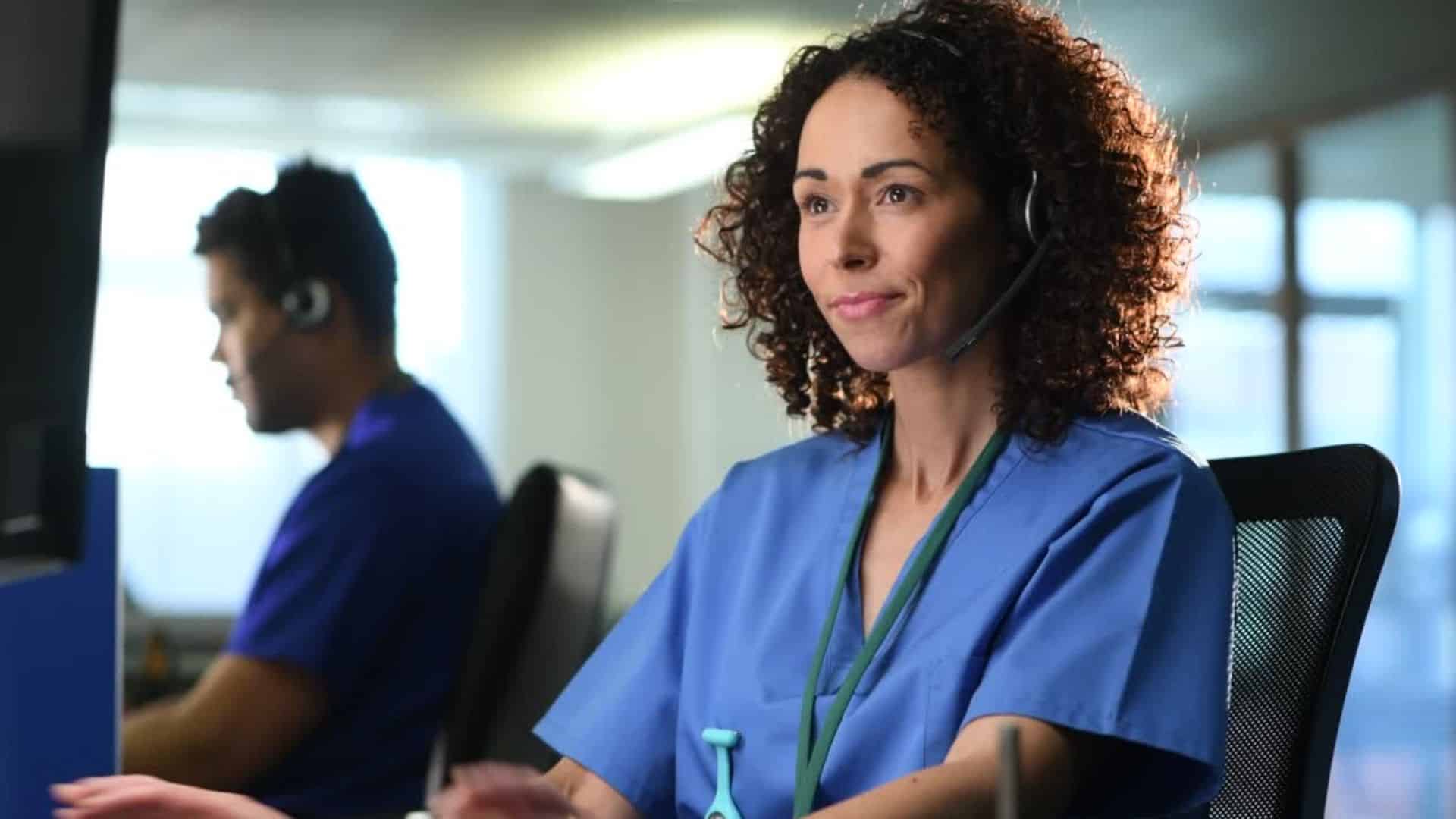 A nurse uses cloud-based triage software at her workstation.