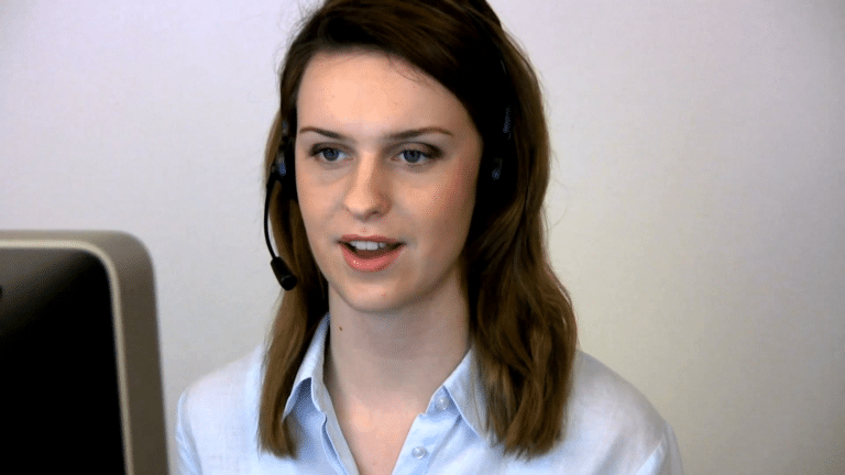 Headshot of a nonclinical operator providing medical answering services for patients from her computer.