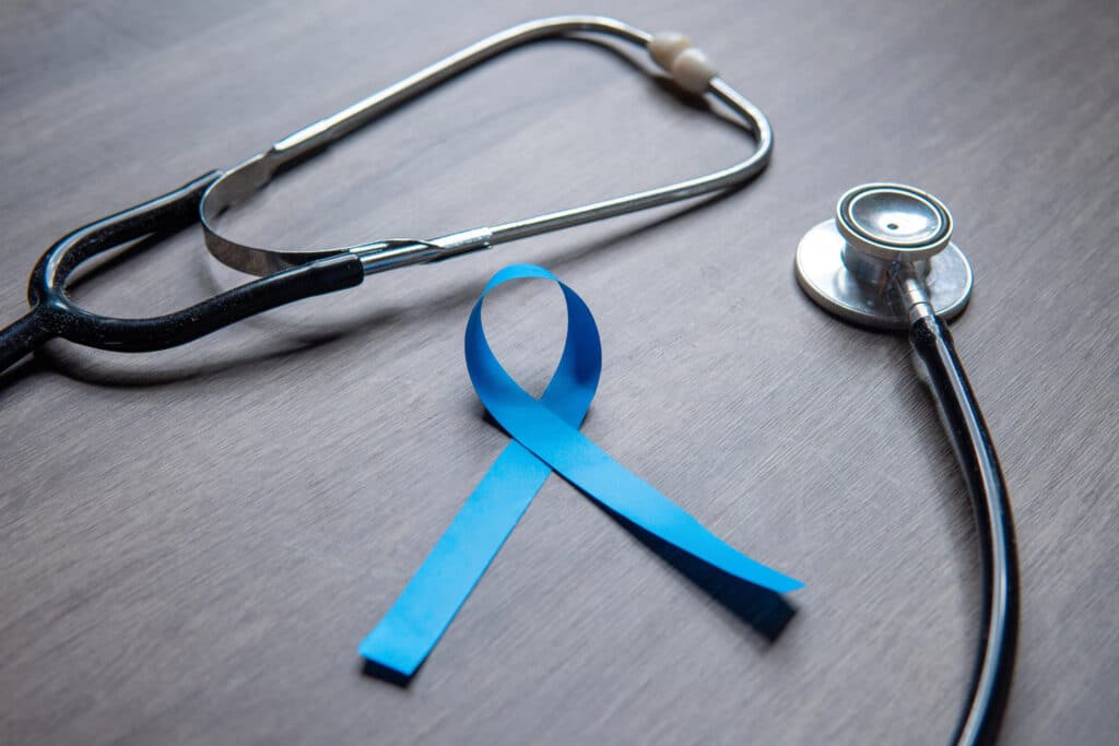 Men's Health Awareness Month is represented by a blue ribbon and a stethoscope.