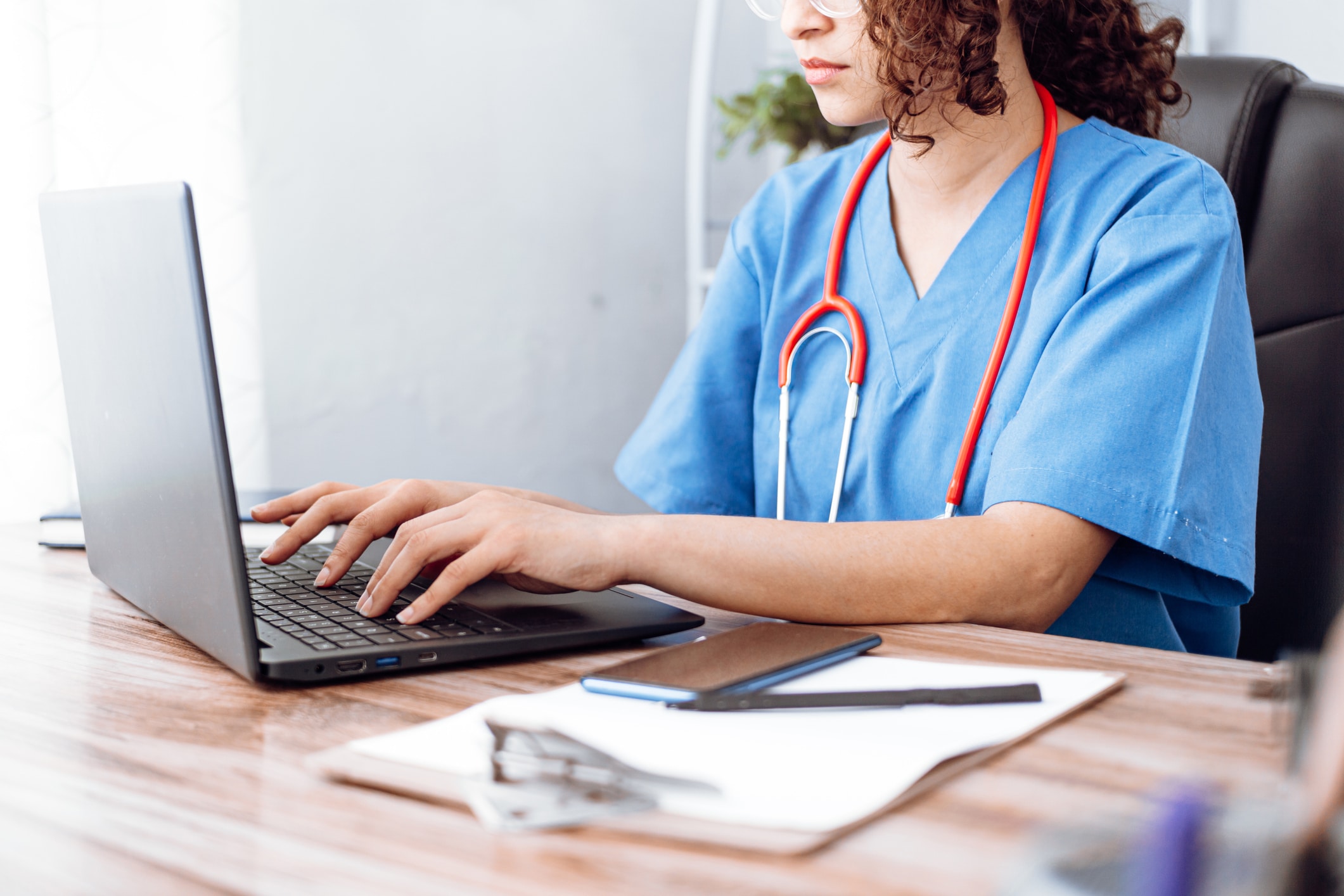 A nurse uses triage software on a computer.