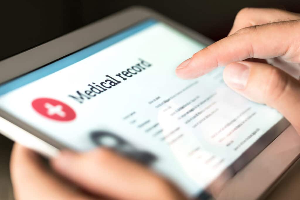 A tablet displays a medical record.