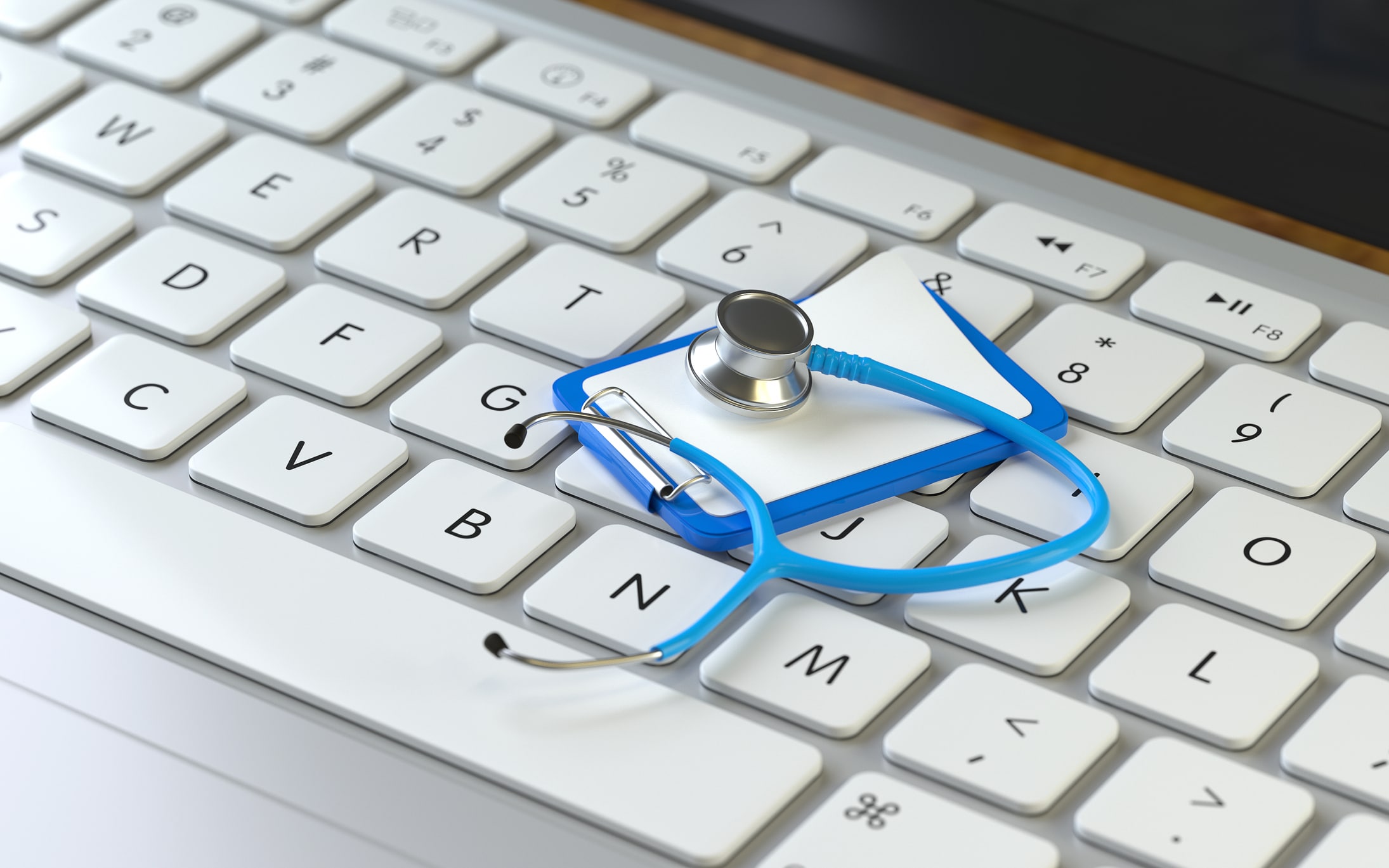 Triage software is represented by a miniature stethoscope and clipboard on top of a computer keyboard.