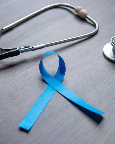 Men's Health Awareness Month is represented by a blue ribbon and a stethoscope.