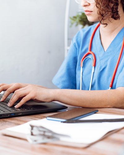 A nurse uses triage software on a computer.