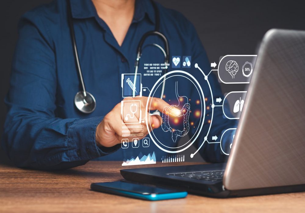 Hand of a doctor touching an image of a colon symbol on a virtual screen while sitting in the hospital. Concept of AI Technology. Business analysis, innovation, technology in science and medicine